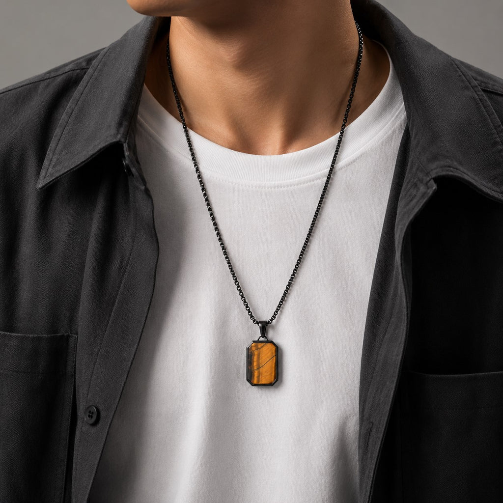 Männer-Halskette mit rechteckigem Tigerauge-Anhänger, schwarzem Edelstahlkettchen, stilvoll kombiniert mit weißem T-Shirt und dunkler Jacke